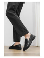 Two-Finish Penny Loafers in Black — on model
