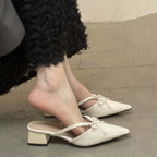 Bow-Strap Block-Heel Mules in Ivory — on model