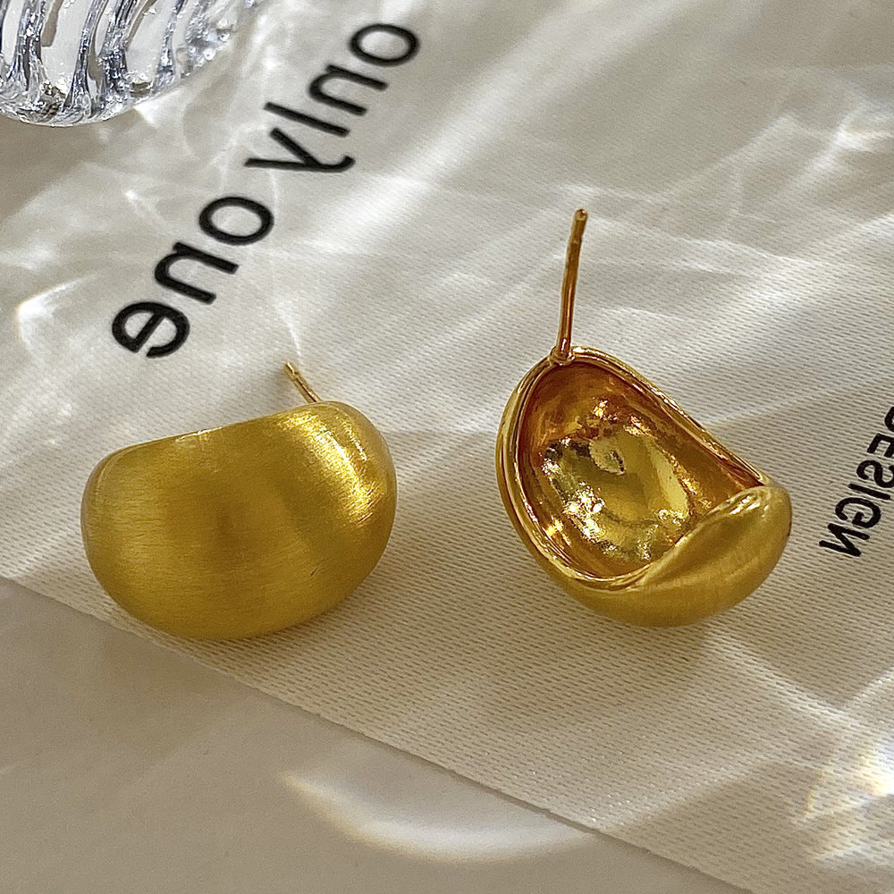 Brushed Gold-Plated Earrings in Open Bean Stud — still life