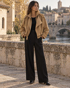 Woman wearing the Camel Bomber Outfit: camel suede-look bomber jacket and black pleated wide-leg trousers