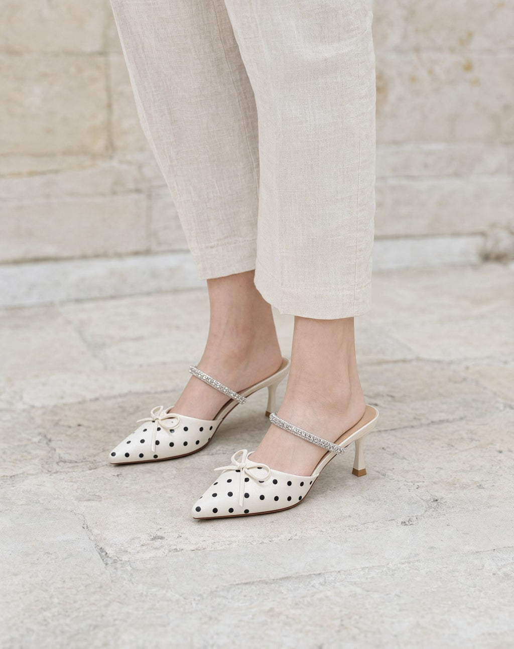 Polka-Dot Rhinestone-Strap Mules in Off-White/Black — on model