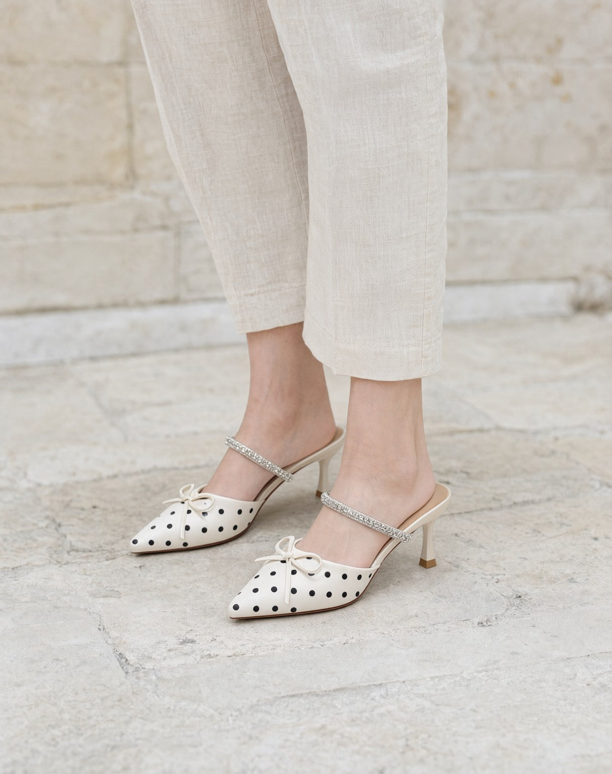 Polka-Dot Rhinestone-Strap Mules in Off-White/Black — on model
